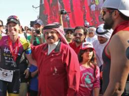 King of Bahrain His Majesty King Hamad bin Isa Al Khalifa surrounded by athletes at an international sporting event