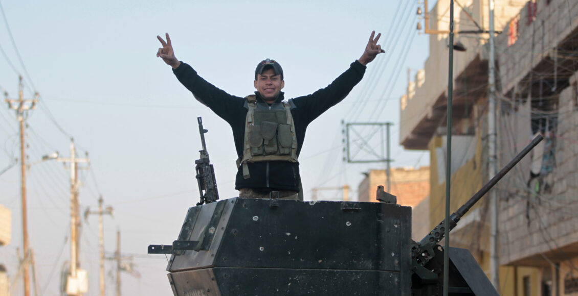 A member of the Iraqi special forces Counter Terrorism Service (CTS) flashes the sign for victory as they advance in Mosul's eastern al-Karamah neighbourhood