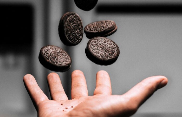 Photo of hand tossing up chocolate cookies